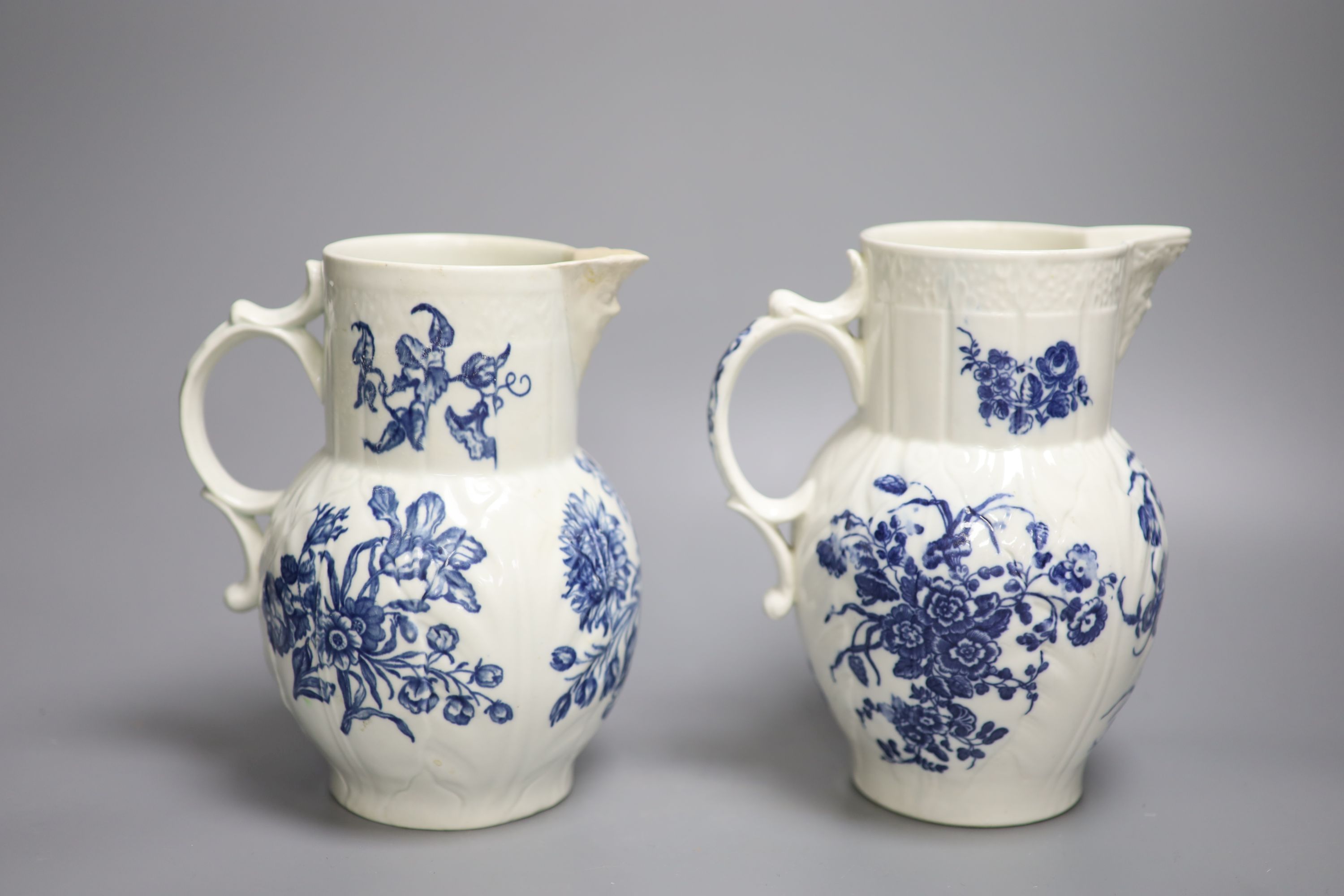 A Caughley mask jug printed with floral sprays and a Worcester mask jug, printed with Natural Sprays, the later with amateur repair to